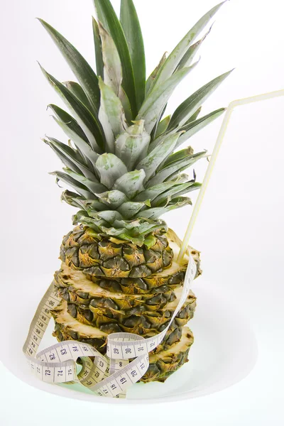 Ananas und Messband auf weißem Hintergrund — Stockfoto