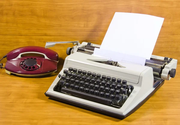 Old typewriter and telephone — Stock Photo, Image