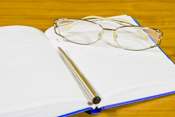 A notebook,is glasses and pen — Stock Photo, Image