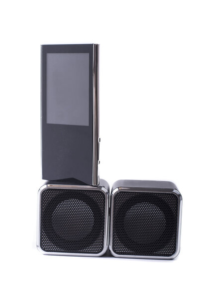 Two square black speakers and mp3 player on its on white background