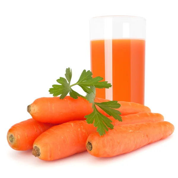 Morot juice glas och morot knölar — Stockfoto