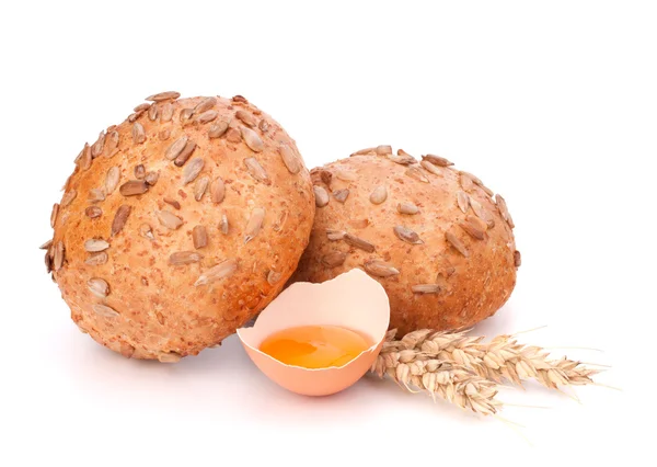 Bun with seeds and broken egg — Stock Photo, Image