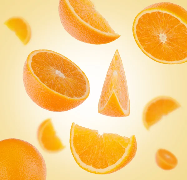 Flying sliced orange fruit segments — Stock Photo, Image