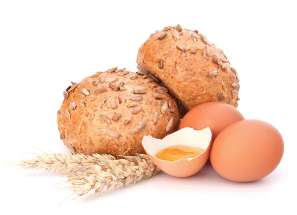 Bun with seeds and broken egg — Stock Photo, Image