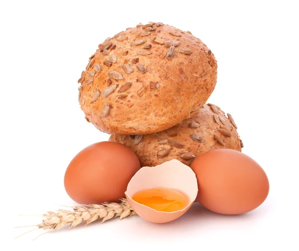 Bun with seeds and broken egg — Stock Photo, Image