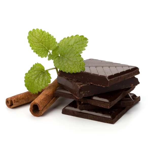 Chocolate bars stack and cinnamon sticks — Stock Photo, Image