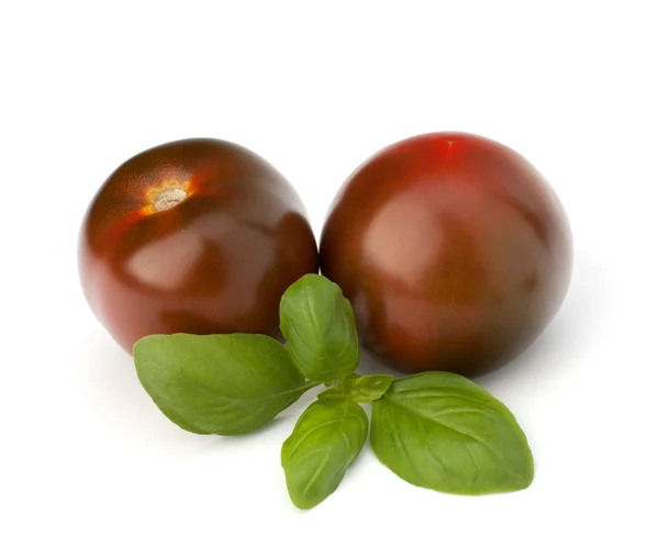 Tomato kumato and basil leaf — Stock Photo, Image