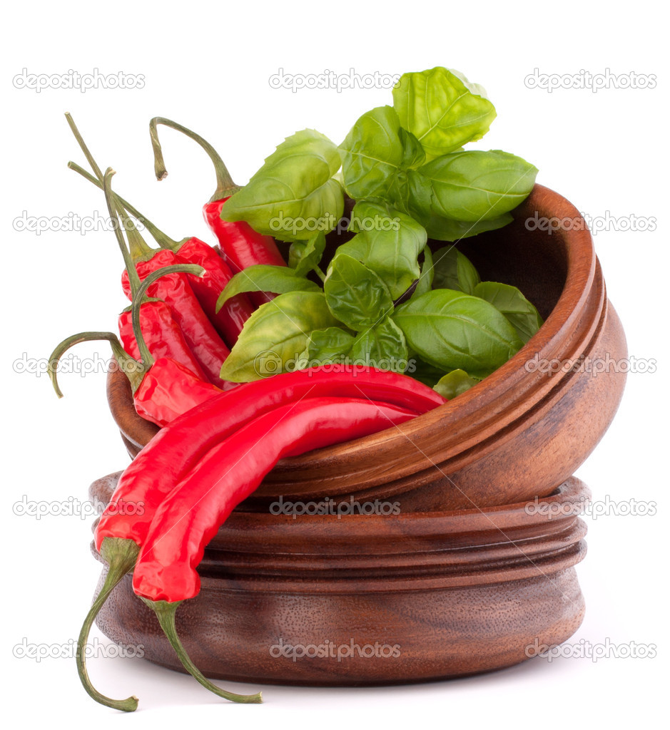 Hot red chili or chilli pepper in wooden bowls stack
