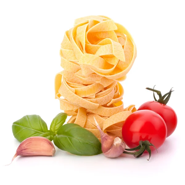 Italian pasta fettuccine nest and cherry tomato — Stock Photo, Image