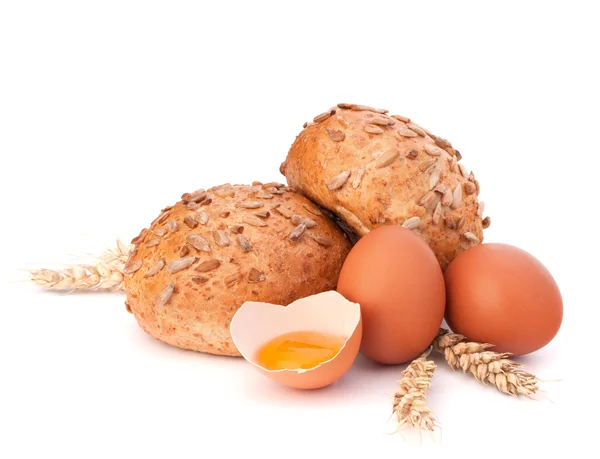 Bun with seeds and broken egg — Stock Photo, Image