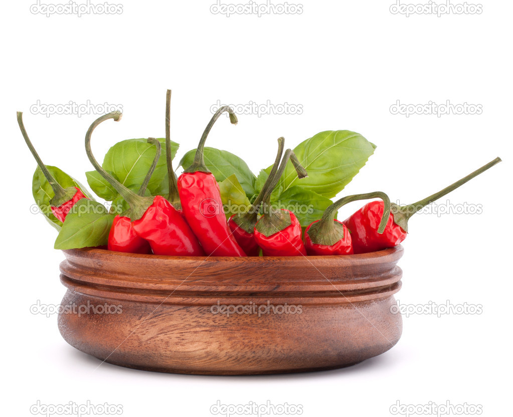 Hot red chili or chilli pepper in wooden bowl