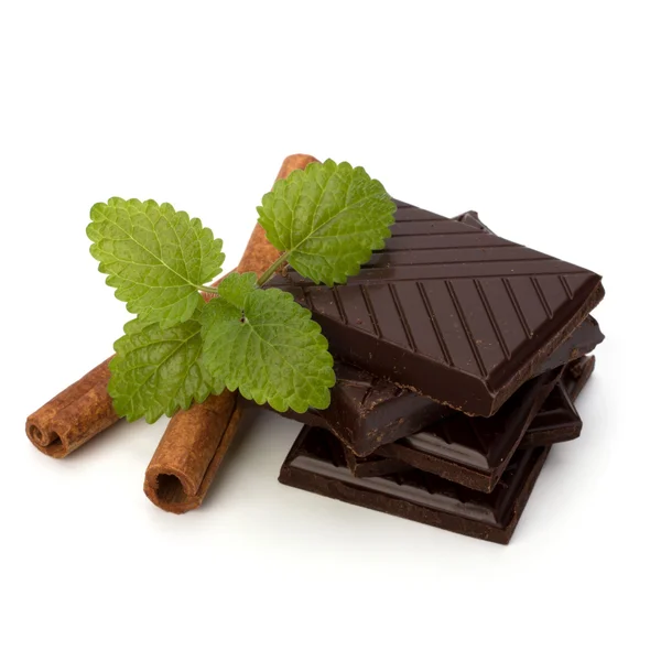 Chocolate bars stack and cinnamon sticks — Stock Photo, Image