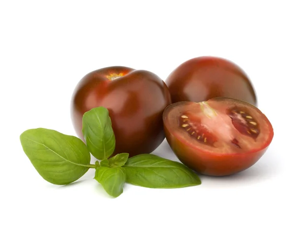 Tomato kumato and basil leaf — Stock Photo, Image