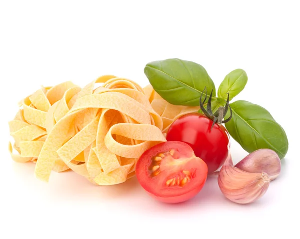 Italian pasta fettuccine nest and cherry tomato — Stock Photo, Image