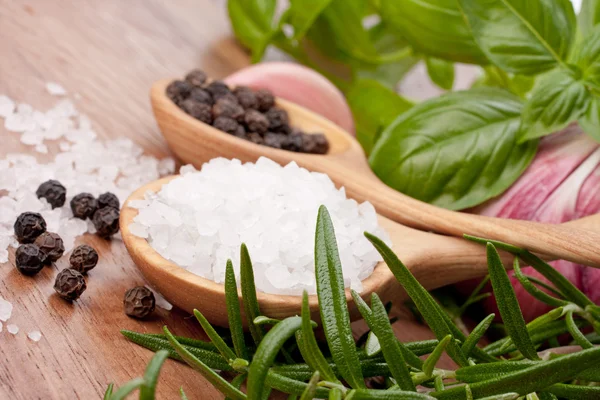 Fresh herbs and salt spoon — Stock Photo, Image