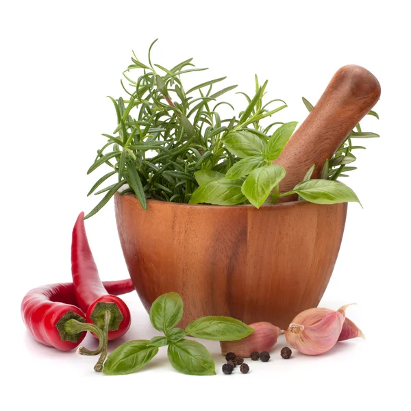 Fresh flavoring herbs and spices in wooden mortar — Stock Photo, Image