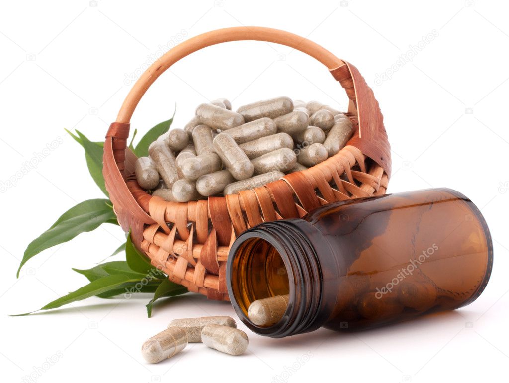 Herbal drug capsules in wicker basket. Alternative medicine conc