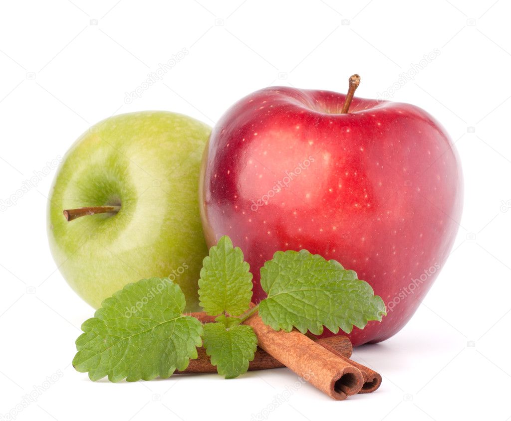Red and green apples, cinnamon sticks and mint leaves still life