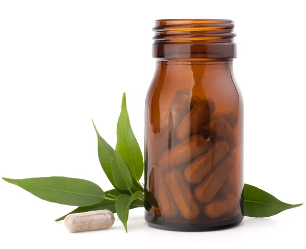 Cápsulas de medicamentos à base de plantas em frasco de vidro marrom. Medicina alternativa — Fotografia de Stock