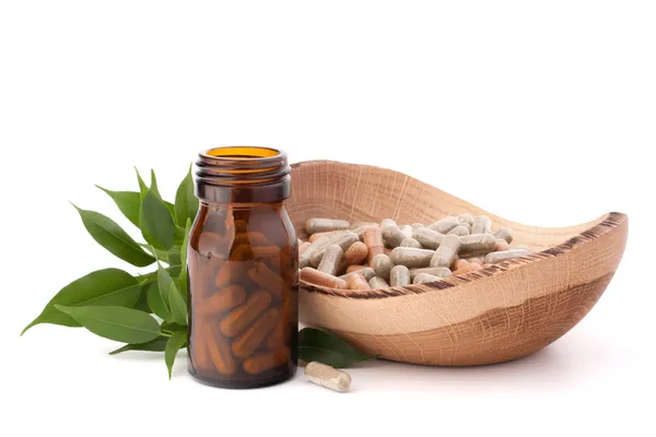 Herbal drug capsules in brown glass bottle. Alternative medicine — Stock Photo, Image