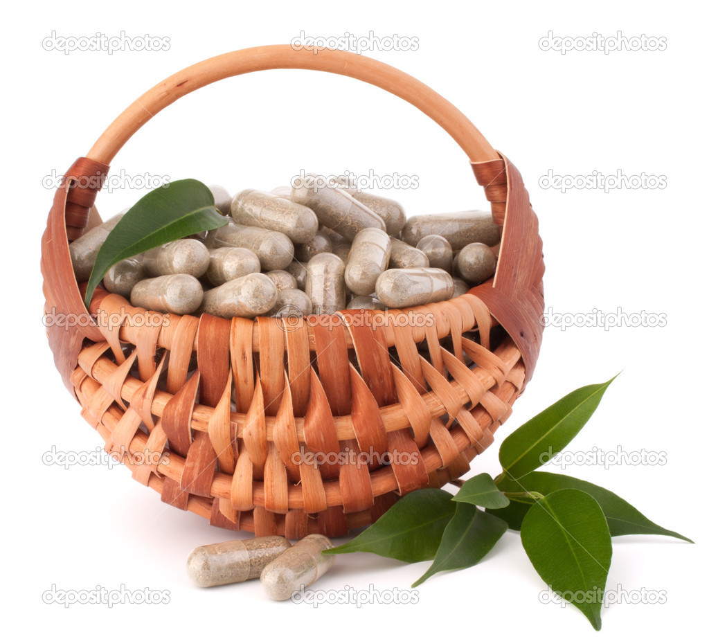 Herbal drug capsules in wicker basket. Alternative medicine conc