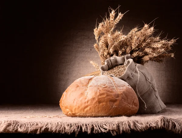 Bread, flour sack and ears bunch still life — Stock Photo, Image