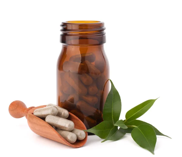 Herbal drug capsules in brown glass bottle. Alternative medicine — Stock Photo, Image