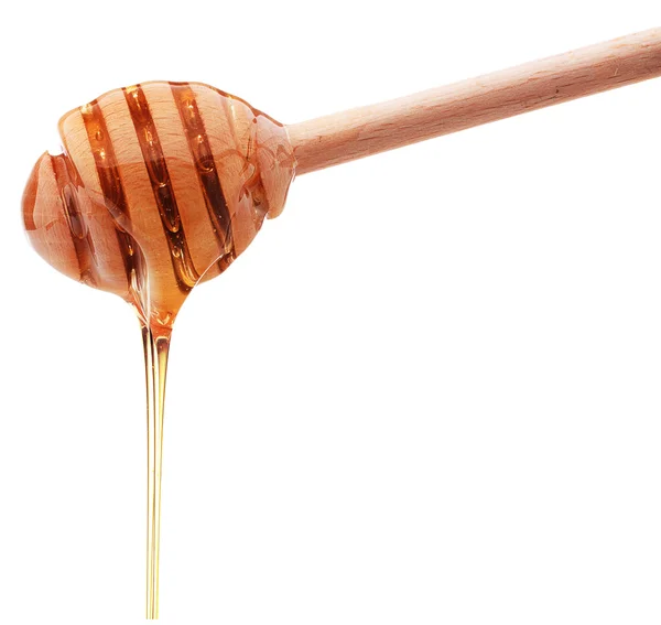 Honig tropft aus einem hölzernen Honigwagen isoliert auf weißem Rücken — Stockfoto