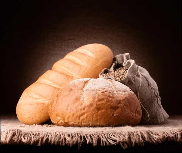 Wheat bread and flour sack still life — Stock Photo, Image