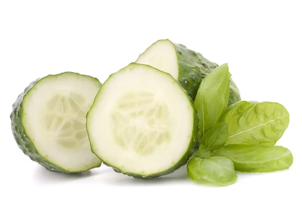 Sliced cucumber vegetable and basil leaves still life — Stock Photo, Image