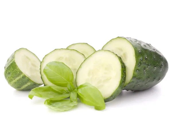 Sliced cucumber vegetable and basil leaves still life — Stock Photo, Image