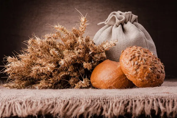 Bread, flour sack and ears bunch still life — Stock Photo, Image