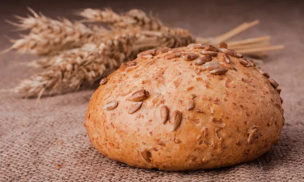 Loaf of bread and wheat ears still life — Stock Photo, Image