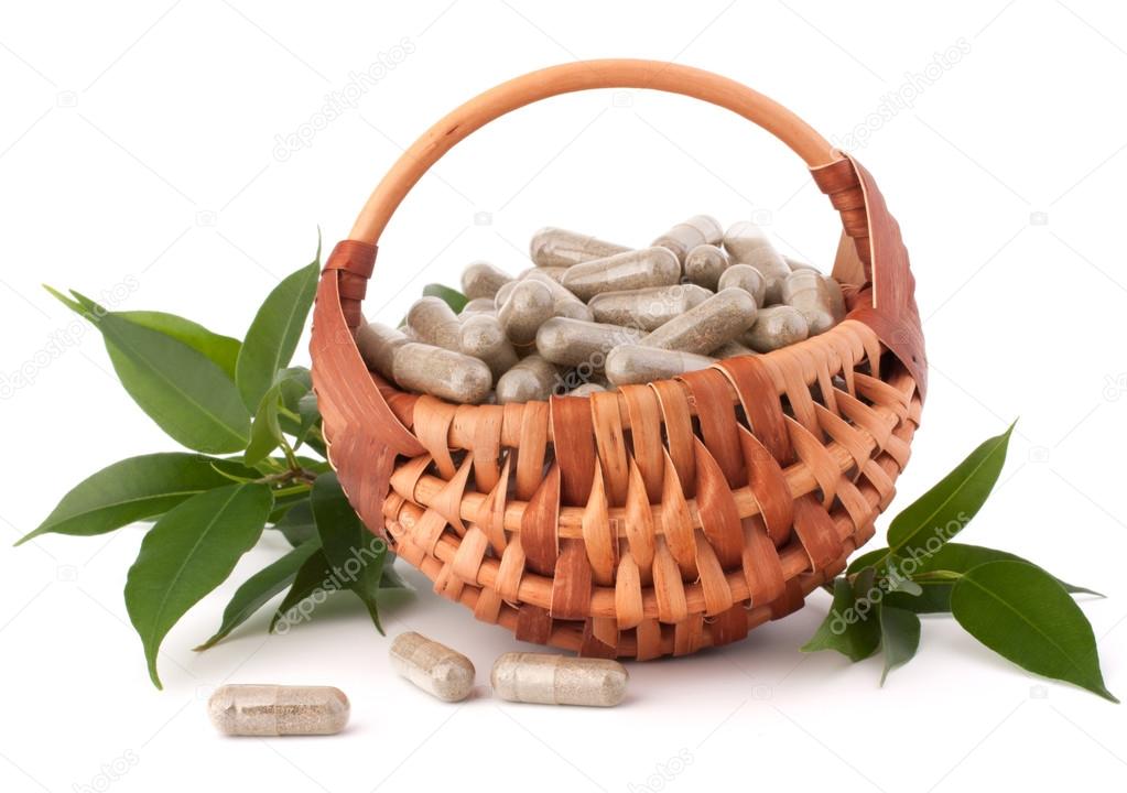 Herbal drug capsules in wicker basket.