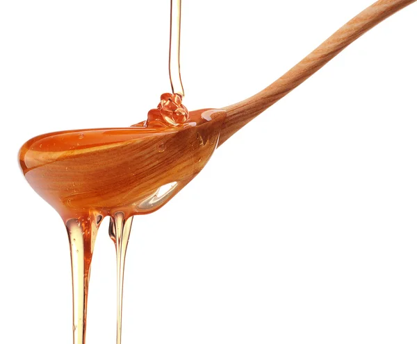 Miel dégoulinant sur une cuillère — Photo