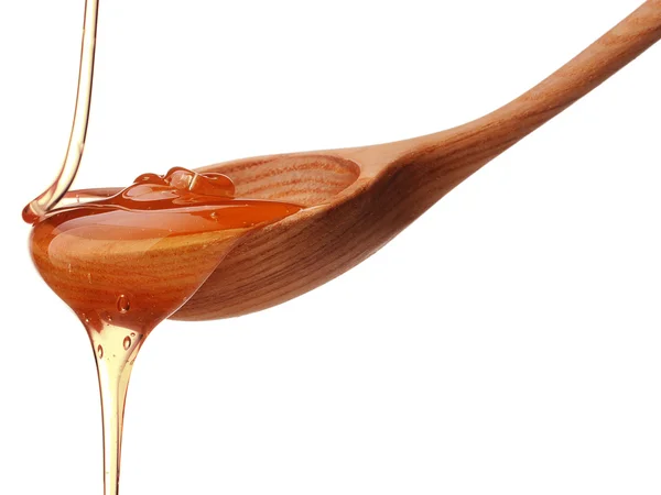 Miele gocciolante da un cucchiaio di legno — Foto Stock