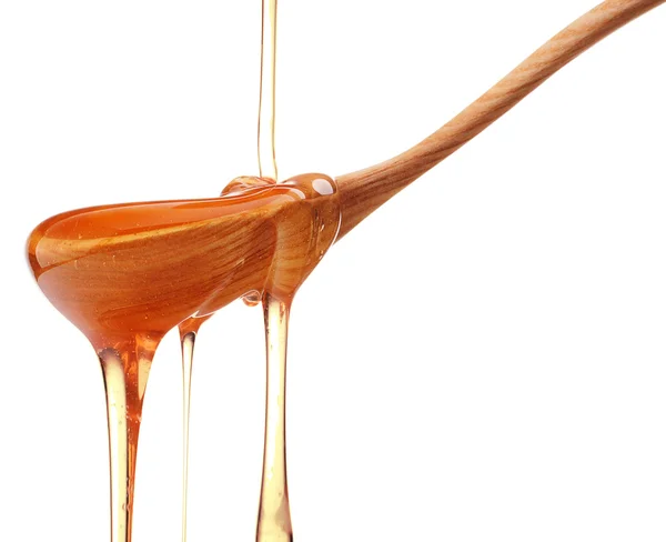 Miel goteando de un tarro de miel de madera — Foto de Stock