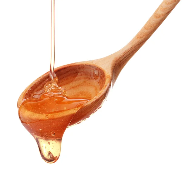 蜂蜜从木制蜂蜜搅拌器上滴下 — 图库照片