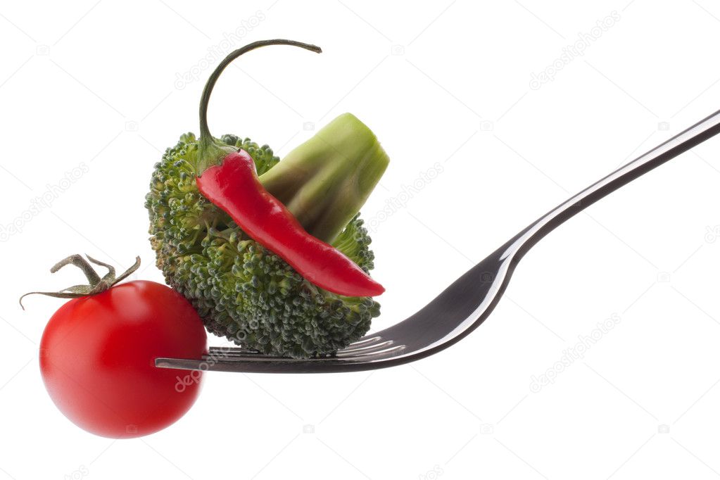 Fresh raw vegetables on fork isolated on white background cutout