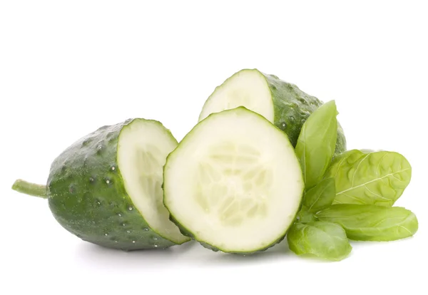 Sliced cucumber vegetable and basil leaves still life — Stock Photo, Image