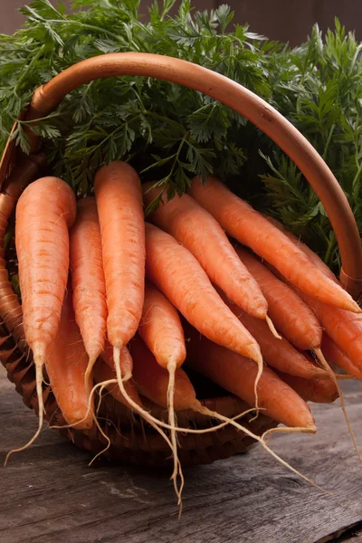 Fresh carrots in wicker basket — Stock Photo, Image