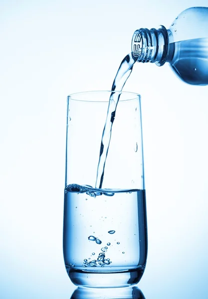 Pouring water from glass pitcher — Stock Photo, Image
