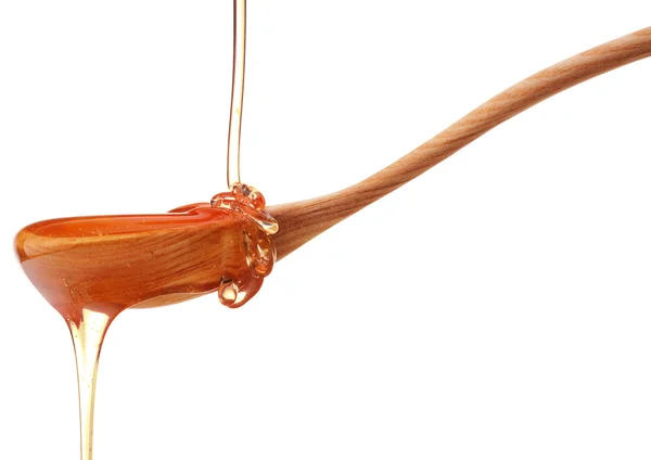Мед капает из деревянного медового котла — стоковое фото