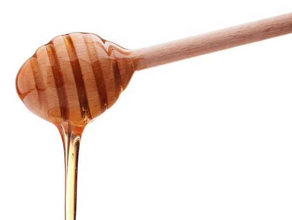 Honung droppar från en trä honung dipper — Stockfoto