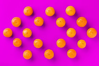 Leylak arka plan üzerinde taze portakal mandalina veya mandalina Meyve desen. Düz yatıyordu, üstten bak. Pop art tasarımı, yaratıcı yaz konsepti. Minimal tarzda narenciye.