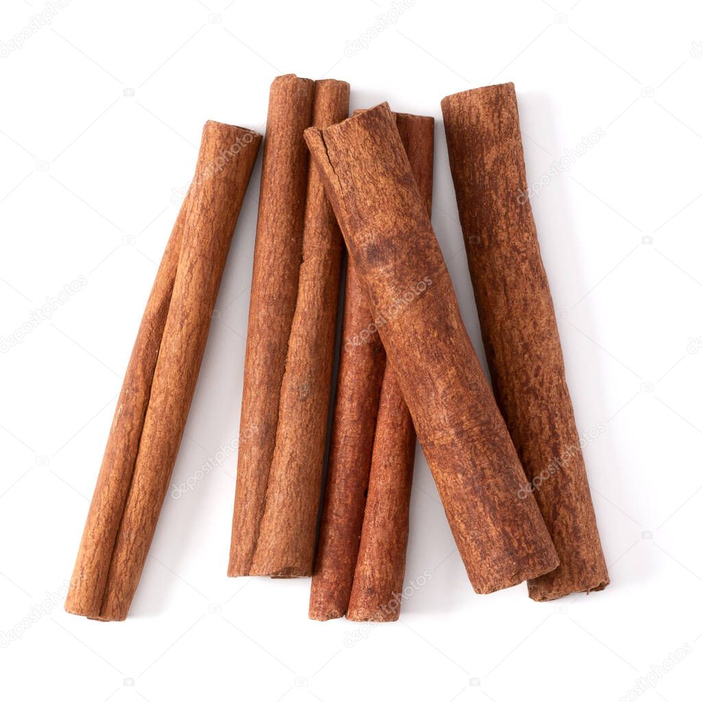 Cinnamon sticks isolated over white background closeup. Canella spice. Aromatic condiment background. Flat lay, top view.