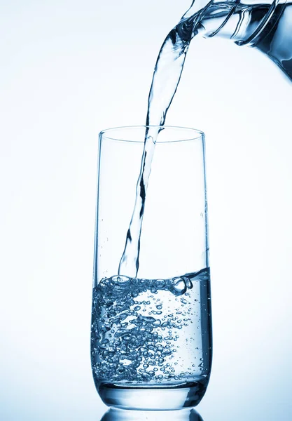 Pouring Water Glass Pitcher Blue Background — Stock Photo, Image