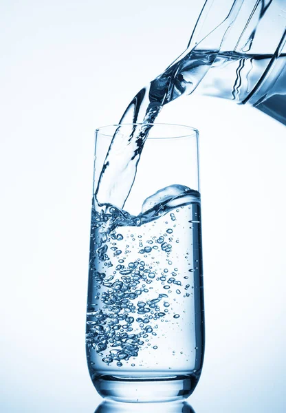 Pouring Water Glass Pitcher Blue Background — Stock Photo, Image