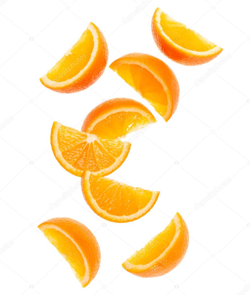 falling fresh orange fruit slices isolated on white background closeup. Flying food concept. Top view. Flat lay. Orange slice in air, without shadow.