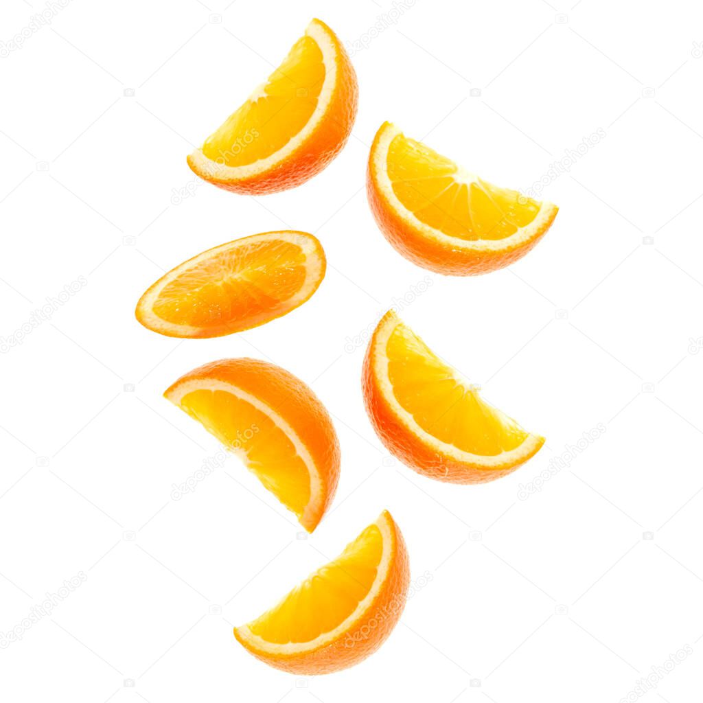 falling fresh orange fruit slices isolated over white background closeup. Flying food concept. Top view. Flat lay. Orange slice in air, without shadow.